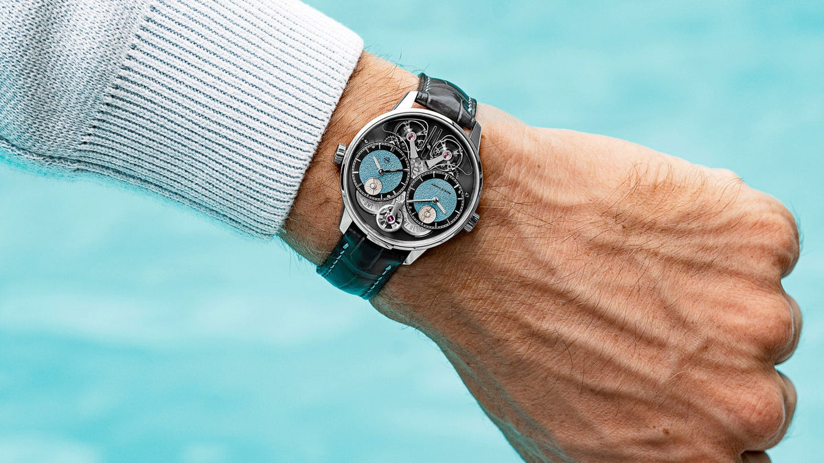 Armin Strom Dual Time GMT Resonance First Edition worn on the wrist against turquoise water