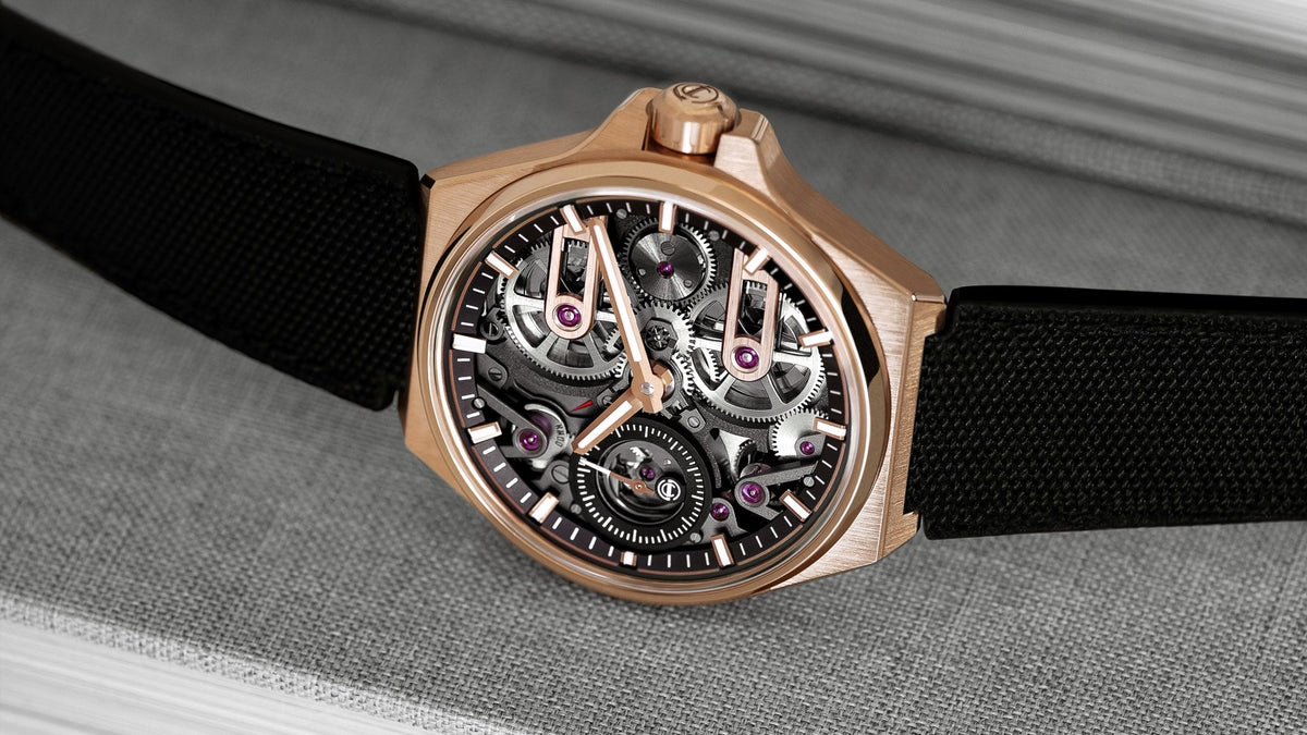 Armin Strom One Week Skeleton Rose Gold resting against a stack of books, three-quarter view of the skeletonised movement