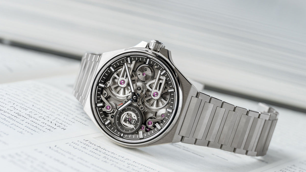 Armin Strom One Week Titanium Skeleton resting on an open book, angled view