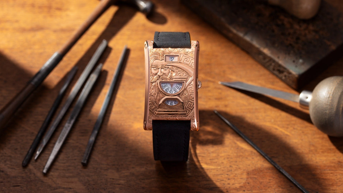 Chronoswiss Neo Digiteur Chronos on an engraver's workbench, gravers and a hammer beside it