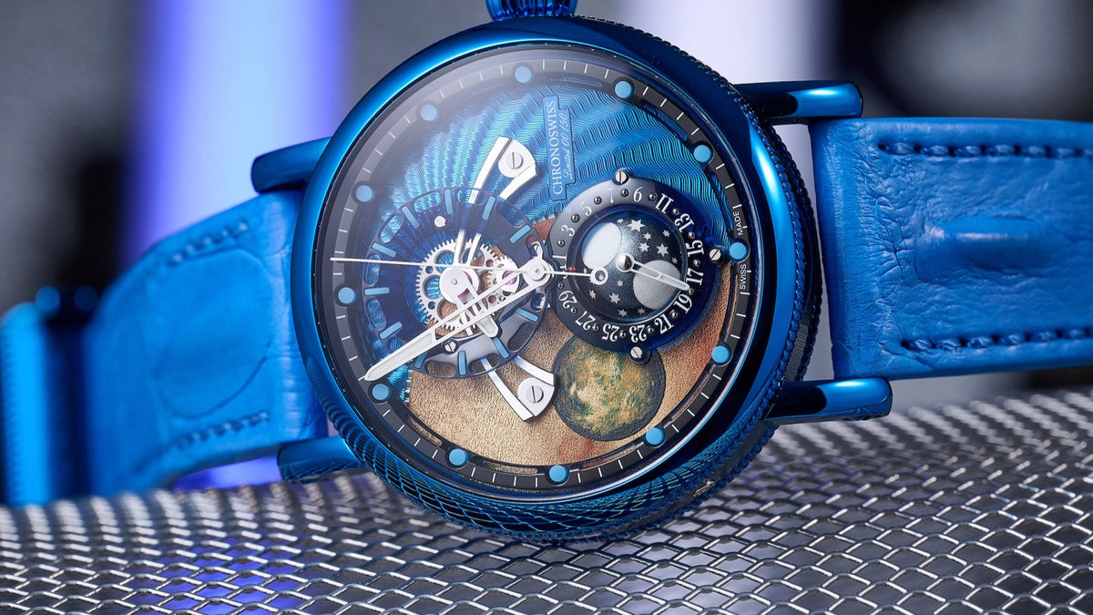 Chronoswiss Space Timer Deep Space in blue CVD steel with blue strap, dial showing Jupiter and Io, resting on metal mesh