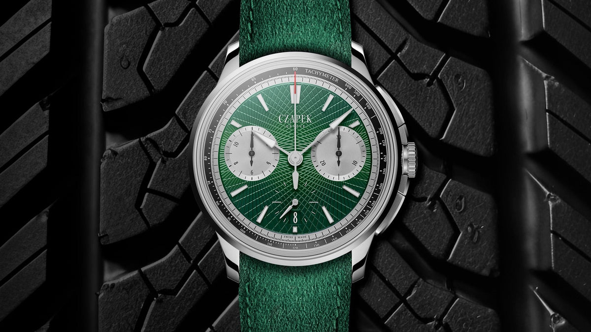 Czapek Faubourg de Cracovie Crossroads Victory Green on its green strap against a black tyre tread