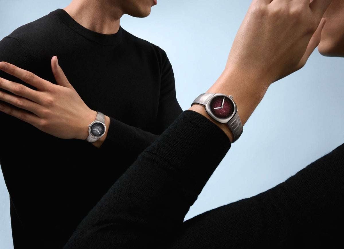 H. Moser & Cie. Streamliner Two Hands worn on two wrists side by side, 34mm Silver fumé and 28mm Burgundy fumé
