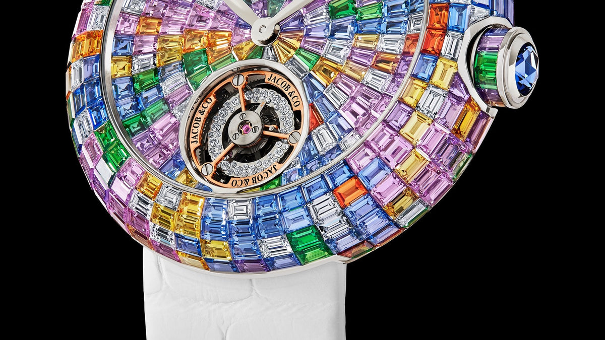 Jacob & Co. Brilliant Flying Tourbillon Baguette Pastel Arlequino in close profile against black, its pastel sapphires and diamond-set balance wheel catching the light