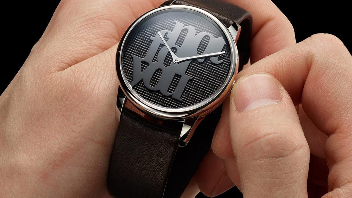 Louis Erard x Monica Bonvicini ‘Not For You’ cradled in two hands, the mirror-polished dial catching the light