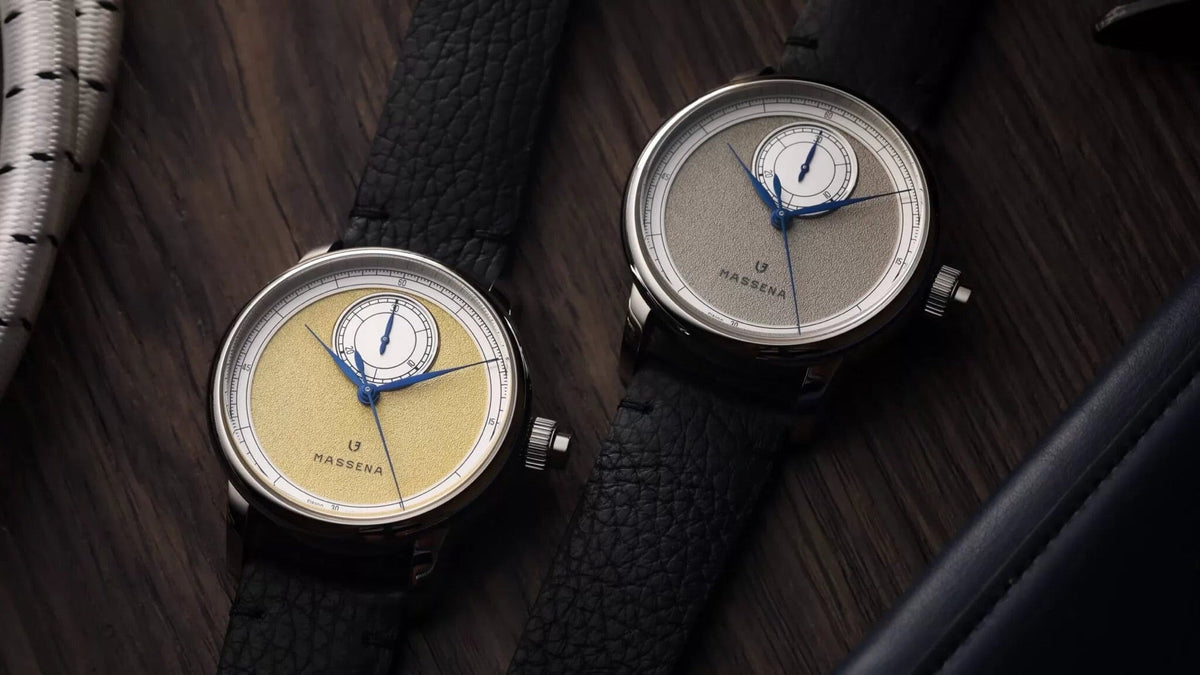 Le Chronographe Monopoussoir Louis Erard x Massena LAB, Gold and Silver on a wooden table