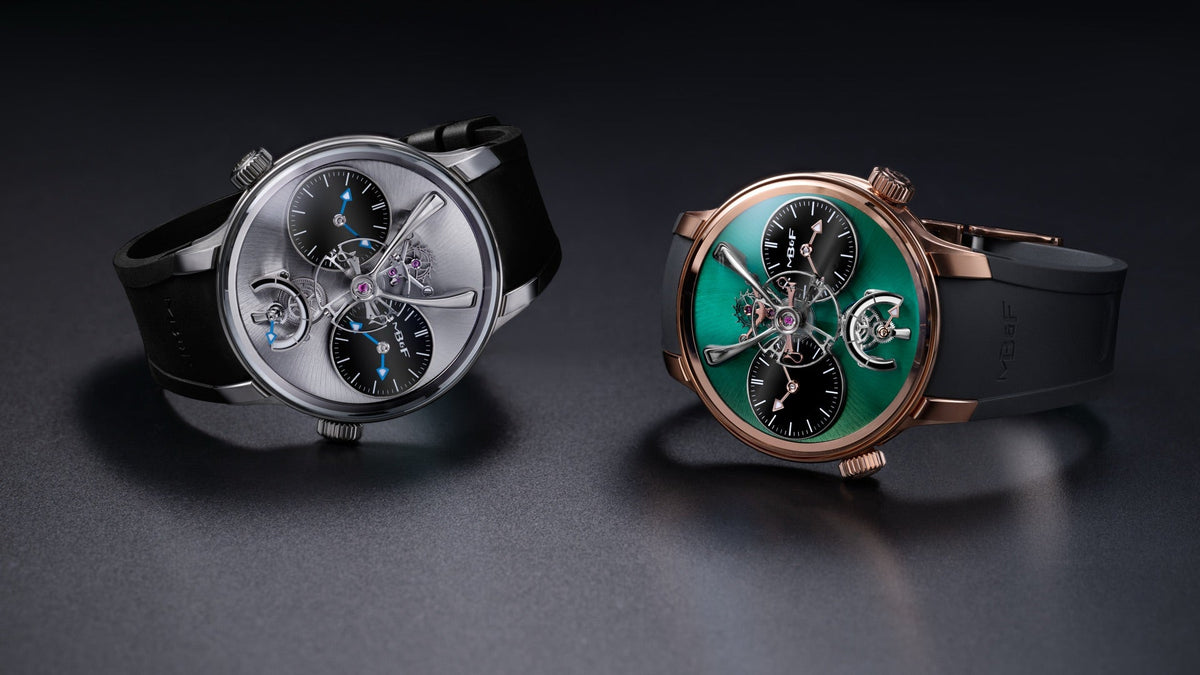 MB&F LM1 EVO in titanium and in rose gold, side by side on a dark floor