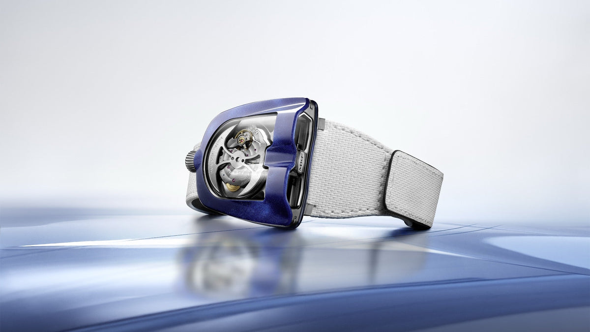MB&F HM8 Mark 2 Blue with white rubber strap on a reflective blue surface