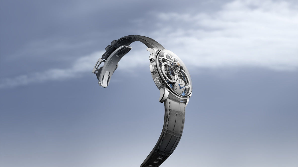MB&F Legacy Machine Sequential Flyback Platinum on its grey alligator strap, floating against a cloudy sky