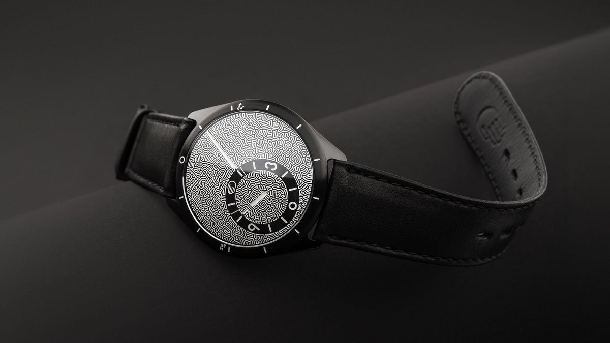 Ressence TYPE 9 Jules Wittock Black, angled on a dark surface, the maze dial catching the light
