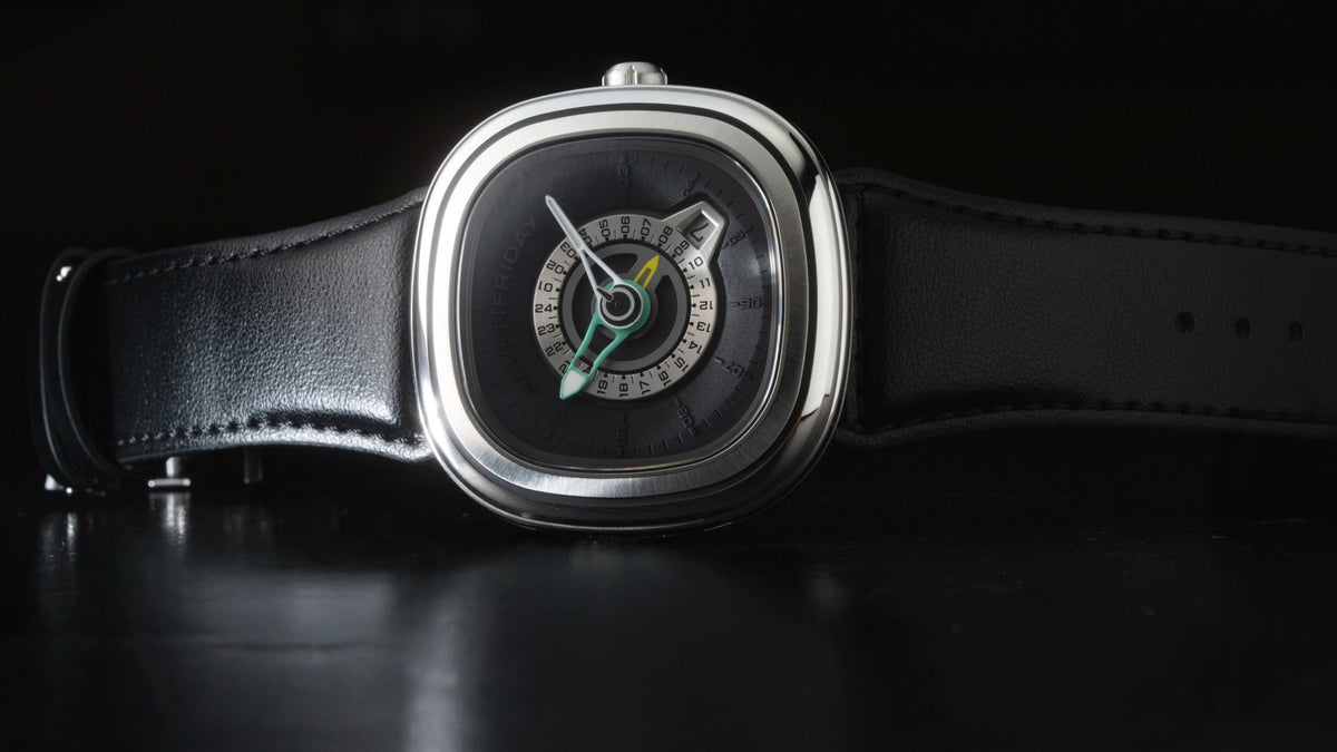 SEVENFRIDAY PG1/01 hero shot on a dark reflective surface