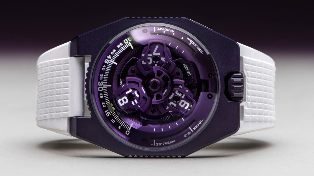 URWERK UR-100V UltraViolet with violet case and satellite hours, on a white textured rubber strap