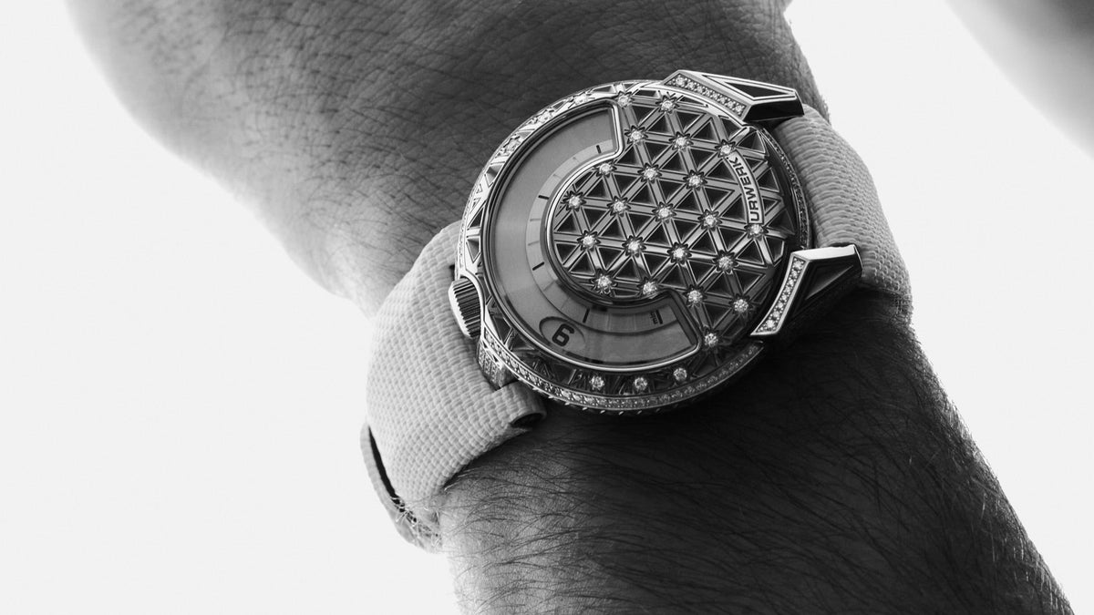URWERK UR-101 Diamond Sky worn on the wrist, black-and-white, close view of the engraved diamond-set case